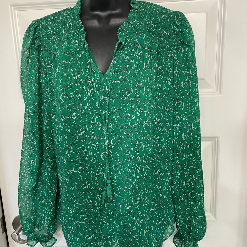 Long sleeve blouse with tie neck and ruffled sleeve cuffs. Size medium
